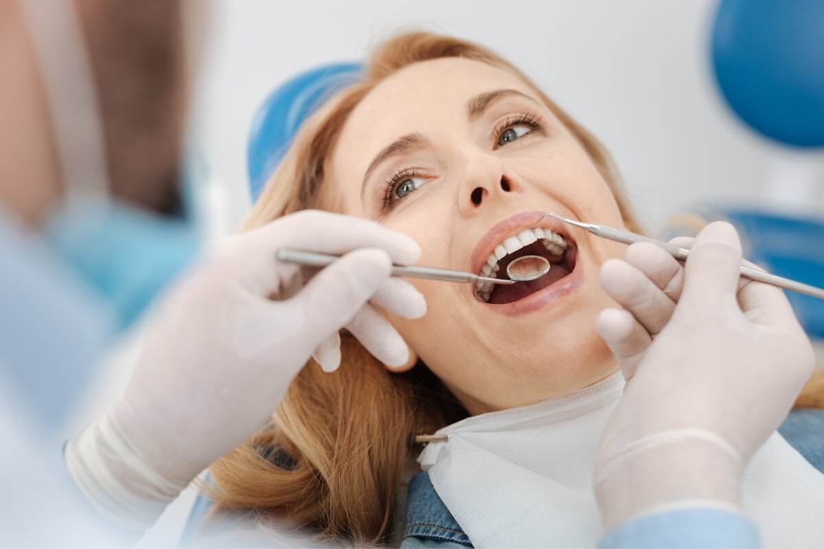 Dentist-Cleaning-Patients-Teeth Dentist Cleaning Patient Teeth
