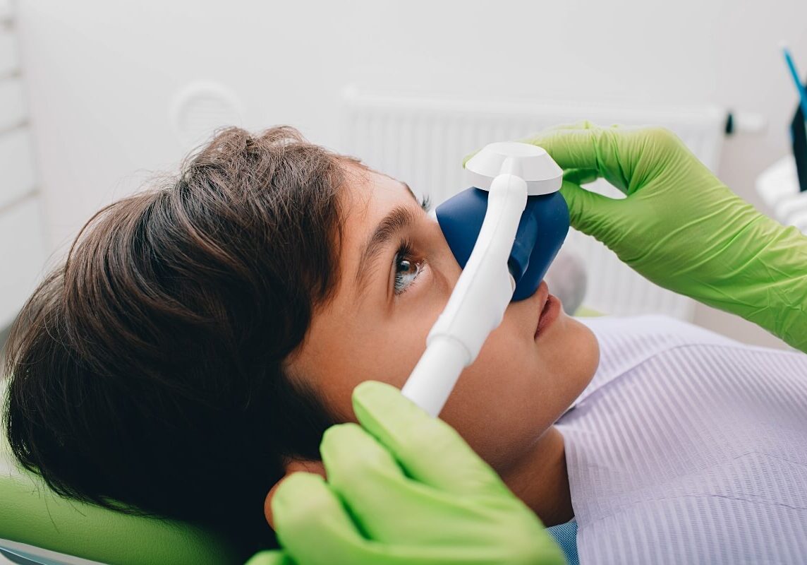 Boy Getting Inhalation Sedation While Teeth Treatment